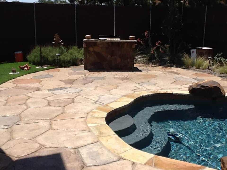 Stamped concrete pool deck with grill area in Plano, Texas