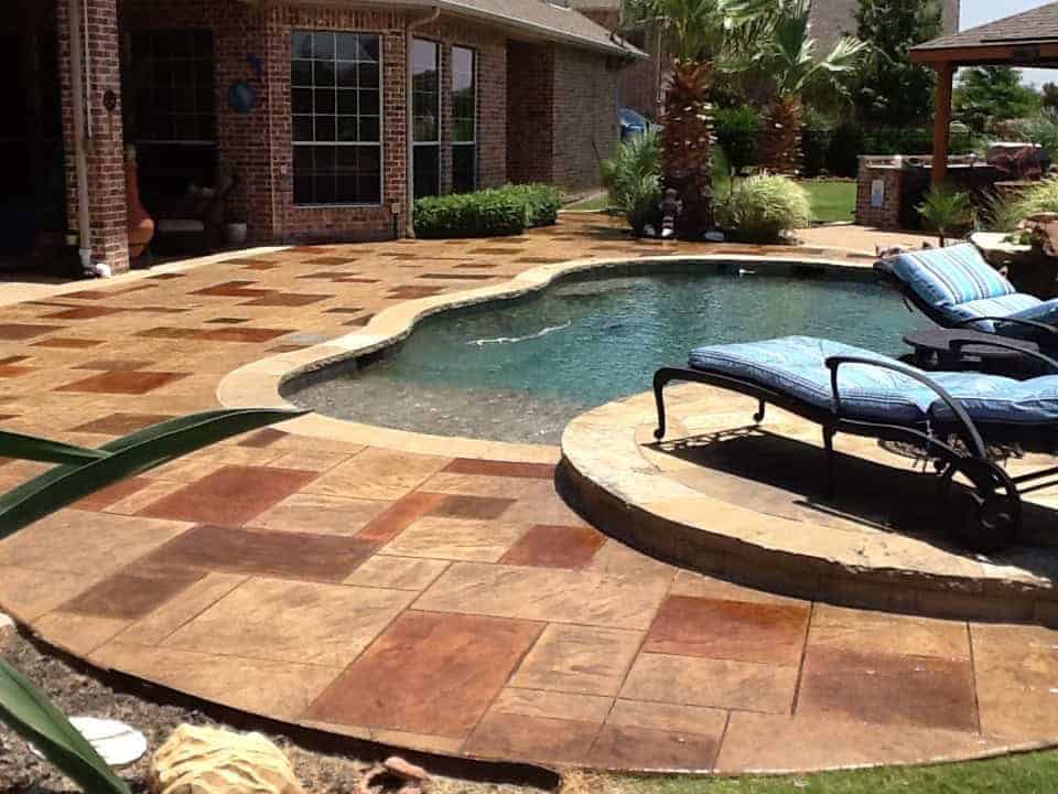 Colored and sealed stamped concrete pool deck in Collin County