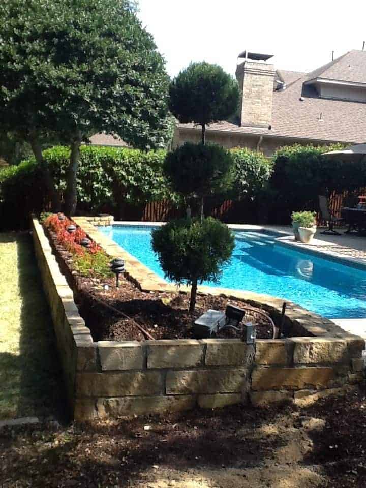 Stone retaining wall installed by Collin County Concrete