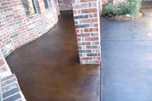 Concrete overlay patio next to brick home